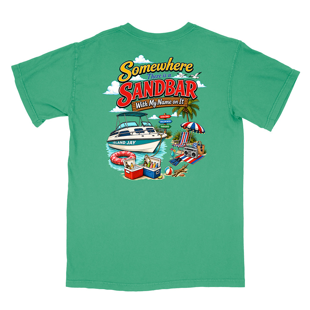 A green short-sleeve t-shirt shown flat against a white background, featuring a colorful graphic print on the back with a boat, beach umbrella, cooler, and the text 'Somewhere on the Sandbar With My Name on It'.