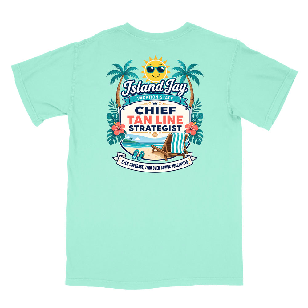 A mint green  short-sleeve t-shirt with a colorful graphic print on the front. The graphic features a smiling sun wearing sunglasses, palm trees, a beach scene, and text that reads 'Island Jay Vacation Staff by CHIEF TAN LINE STRATEGIST'.