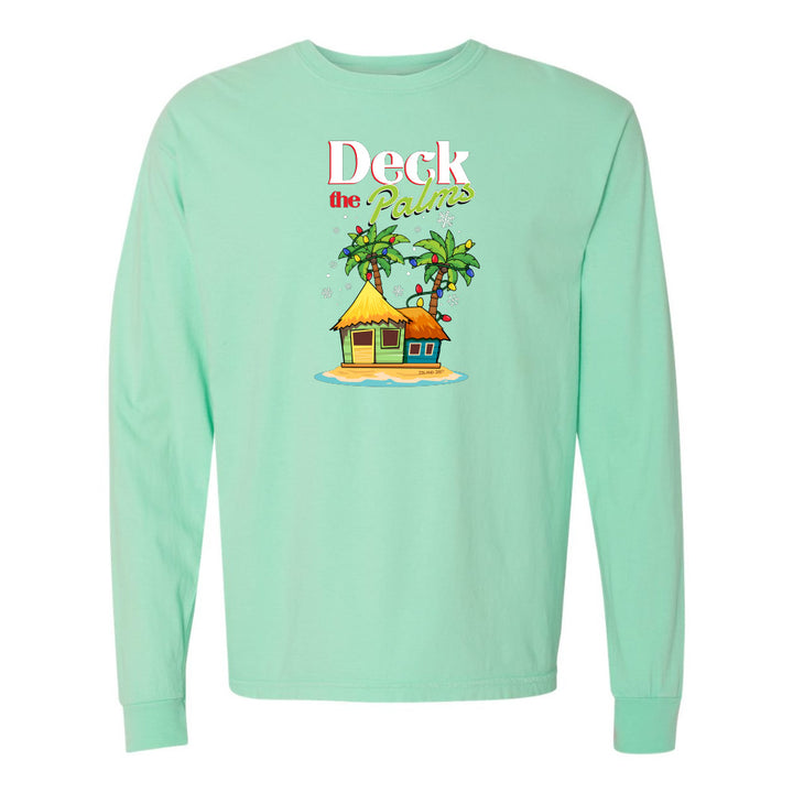 Mint green long-sleeve shirt with a tropical hut and palm tree design and graphic text reading "Deck The Palms" on a white background