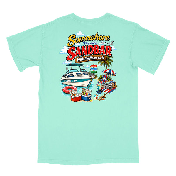 A mint green short-sleeve t-shirt with a colorful graphic print on the back. The graphic features the text 'Somewhere There is a SANDBAR Wish My Name was It' above an illustration of a boat, beach umbrella, cooler, and towels.