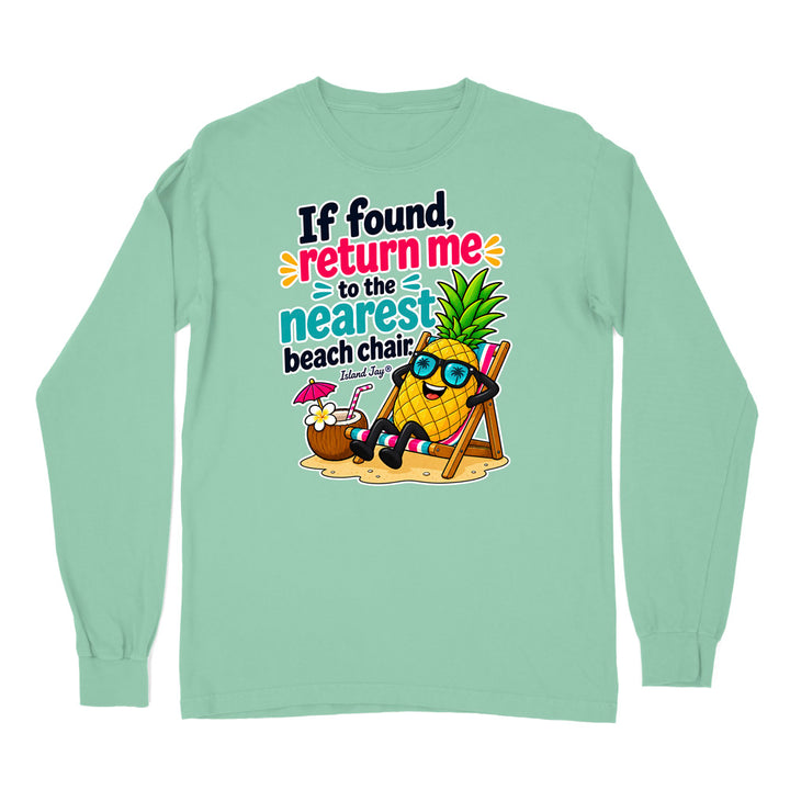 A mint green long-sleeve t-shirt with a colorful graphic print on the front. The graphic features a cartoon pineapple wearing sunglasses and reclining in a beach chair next to a coconut drink, with the text 'If found, return me to the nearest beach chair' and 'Ecuador Surf'.