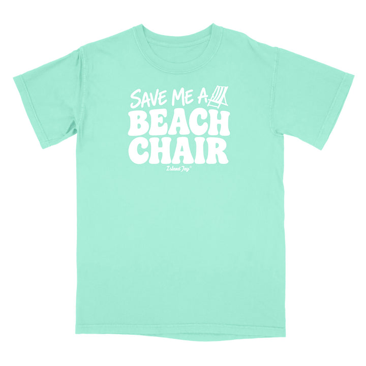 A mint green short-sleeve t-shirt with a bold white graphic on the chest reading 'SAVE ME A BEACH CHAIR' 