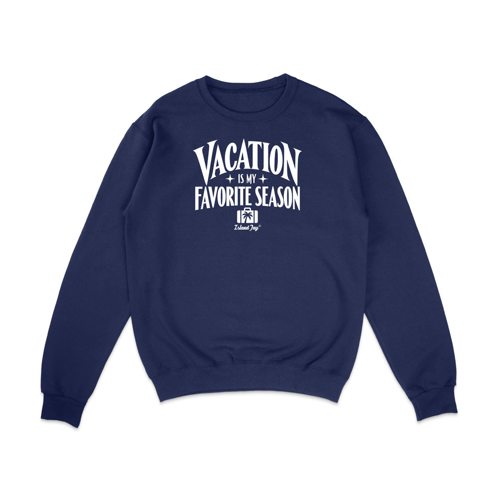 A navy blue crewneck sweatshirt with a white graphic text print on the chest reading 'VACATION IS MY FAVORITE SEASON' and a small 'Krazy Style' logo underneath, displayed on a clean white background.