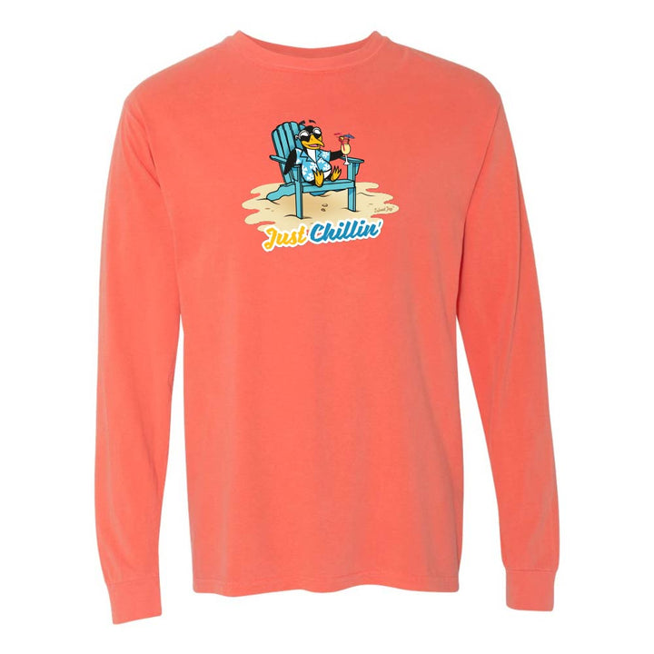 Light orange/red long-sleeve shirt with a graphic of a penguin in an armchair and 'Just Chillin' text.
