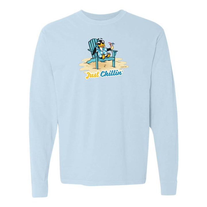 Light blue long-sleeve shirt with a graphic of a penguin in an armchair and 'Just Chillin' text.