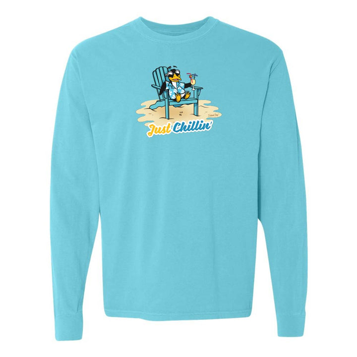 Blue long-sleeve shirt with a graphic of a penguin in an armchair and 'Just Chillin' text.
