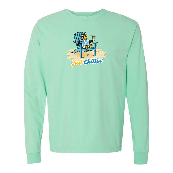 Mint green long-sleeve shirt with a graphic of a penguin in an armchair and 'Just Chillin' text.