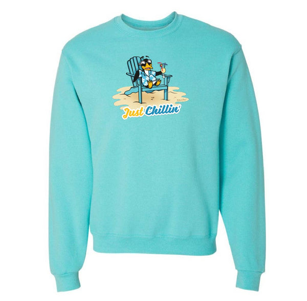 Turquoise sweatshirt with a graphic of a penguin in an adirondack chair and 'Just Chillin' text on a white background.