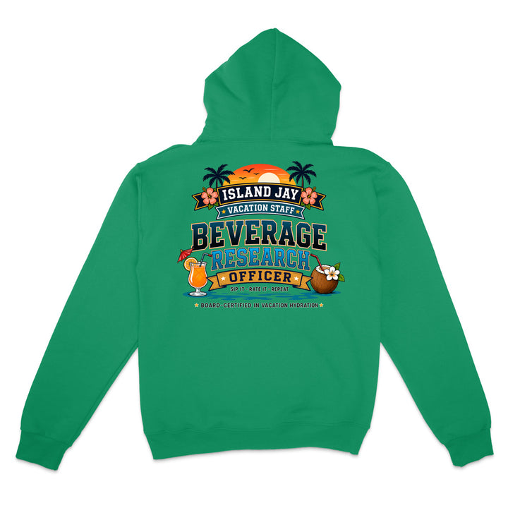 A green pullover hoodie shown from the back, featuring a colorful graphic print that reads 'ISLAND JAY VACATION STAFF BEVERAGE RESEARCH OFFICER' with tropical illustrations including palm trees, a cocktail, a coconut drink, and a sunset.