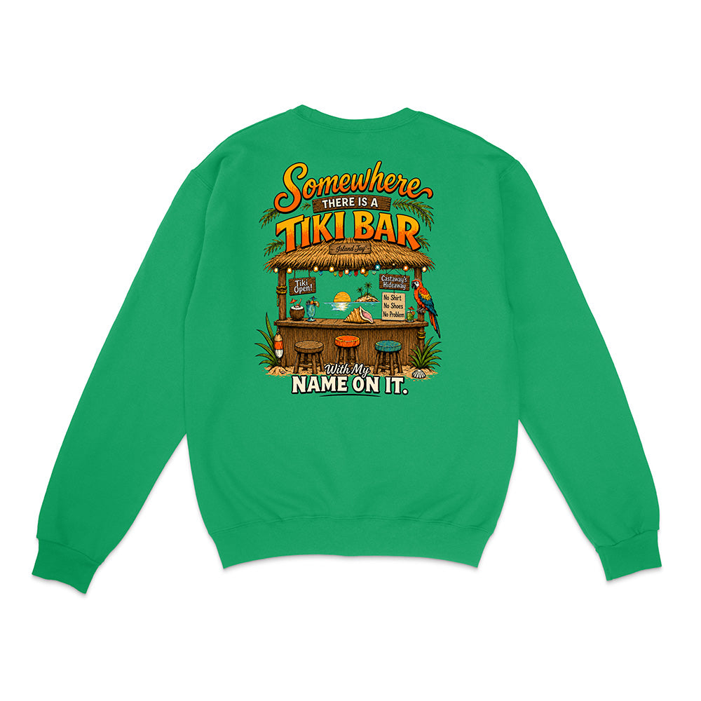 A bright green crewneck sweatshirt shown from the back, featuring a colorful graphic of a tropical 'Tiki Bar' with the text 'Somewhere THERE IS A TIKI BAR and my NAME ON IT.'.