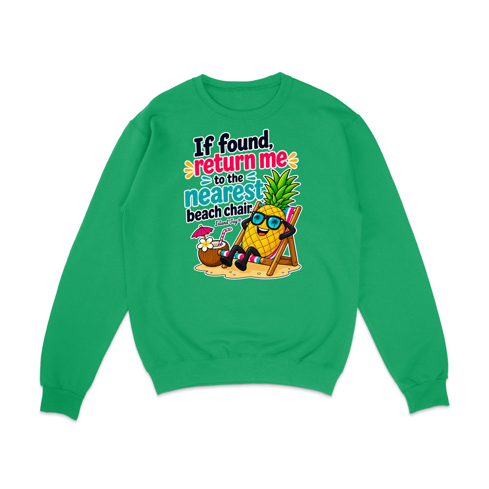 A bright green crewneck sweatshirt with a colorful graphic on the front. The graphic features a cartoon pineapple wearing sunglasses and reclining in a beach chair next to a coconut drink with a pink umbrella, with the text 'If found, return me to the nearest beach chair' in stylized fonts.