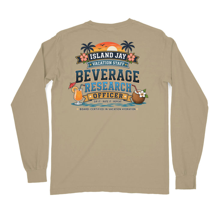 A beige long-sleeve t-shirt shown from the back, featuring a colorful graphic print with tropical island elements and the text 'ISLAND JAY VACATION STAFF BEVERAGE RESEARCH OFFICER'.