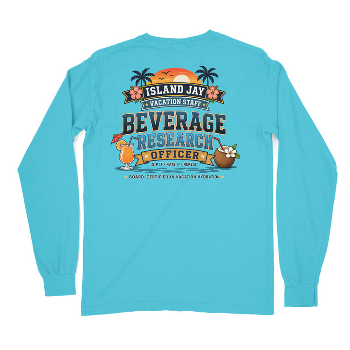 A light blue long-sleeve t-shirt shown from the back, featuring a colorful graphic print with tropical beach elements and the text 'ISLAND JAY VACATION STAFF BEVERAGE RESEARCH OFFICER'.