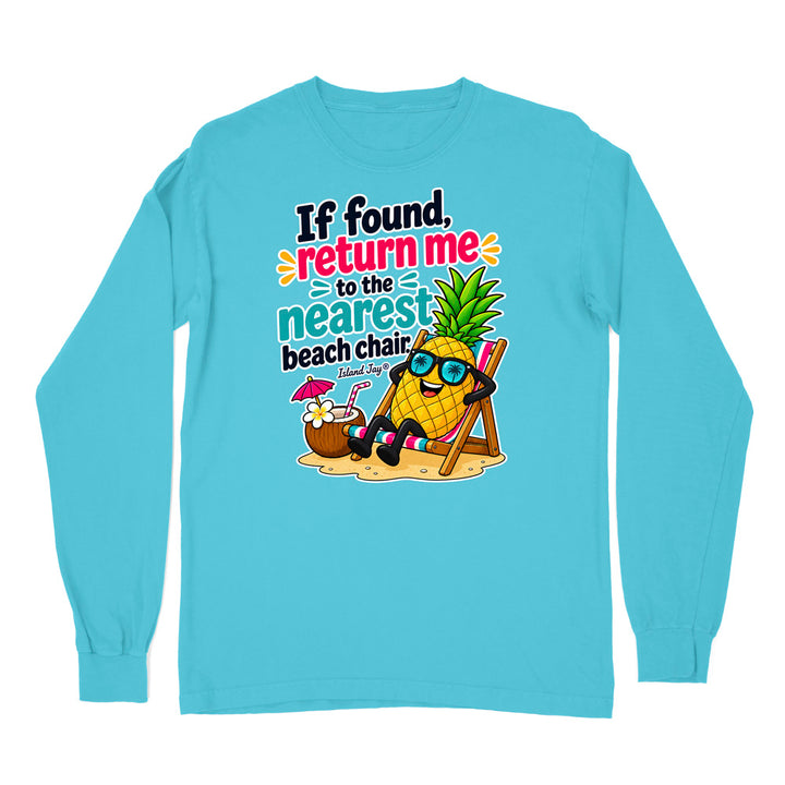 A light blue long-sleeve t-shirt with a colorful graphic on the chest featuring a pineapple character wearing sunglasses and a beach chair next to a coconut drink, with the text 'If found, return me to the nearest beach chair' and 'Eternal Dog'.