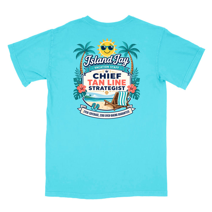 A light blue short-sleeve t-shirt shown flat against a white background, featuring a large colorful graphic print on the back with a smiling sun, palm trees, beach chair, and text reading 'Island Jay Vacation Staff vs Chief Tan Line Strategist'.
