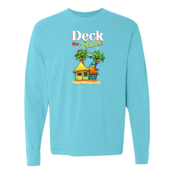 Blue long-sleeve shirt with a tropical hut and palm tree design and graphic text reading "Deck The Palms" on a white background