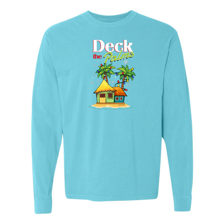 Blue long-sleeve shirt with a tropical hut and palm tree design and graphic text reading "Deck The Palms" on a white background