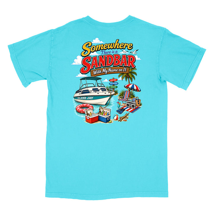 A light blue short-sleeve t-shirt with a colorful graphic print on the back. The graphic features the text 'Somewhere There is SANDBAR Wish My Name was It' above an illustration of a boat, beach umbrella, towels, and a cooler.