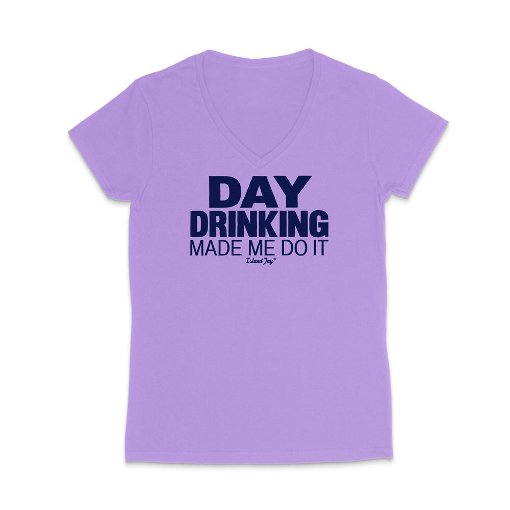 A light purple short-sleeve V-neck t-shirt with a dark navy blue graphic text print reading 'DAY DRINKING MADE ME DO IT' on the chest, displayed against a solid white background.