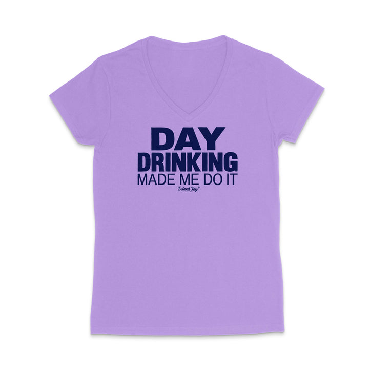 A light purple short-sleeve V-neck t-shirt with a dark navy blue graphic text print reading 'DAY DRINKING MADE ME DO IT' on the chest, displayed against a solid white background.