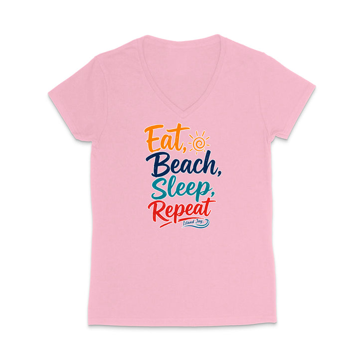 A light pink women's V-neck t-shirt with a colorful graphic text print reading 'Eat, Beach, Sleep, Repeat' on the front, displayed on a clean white background.