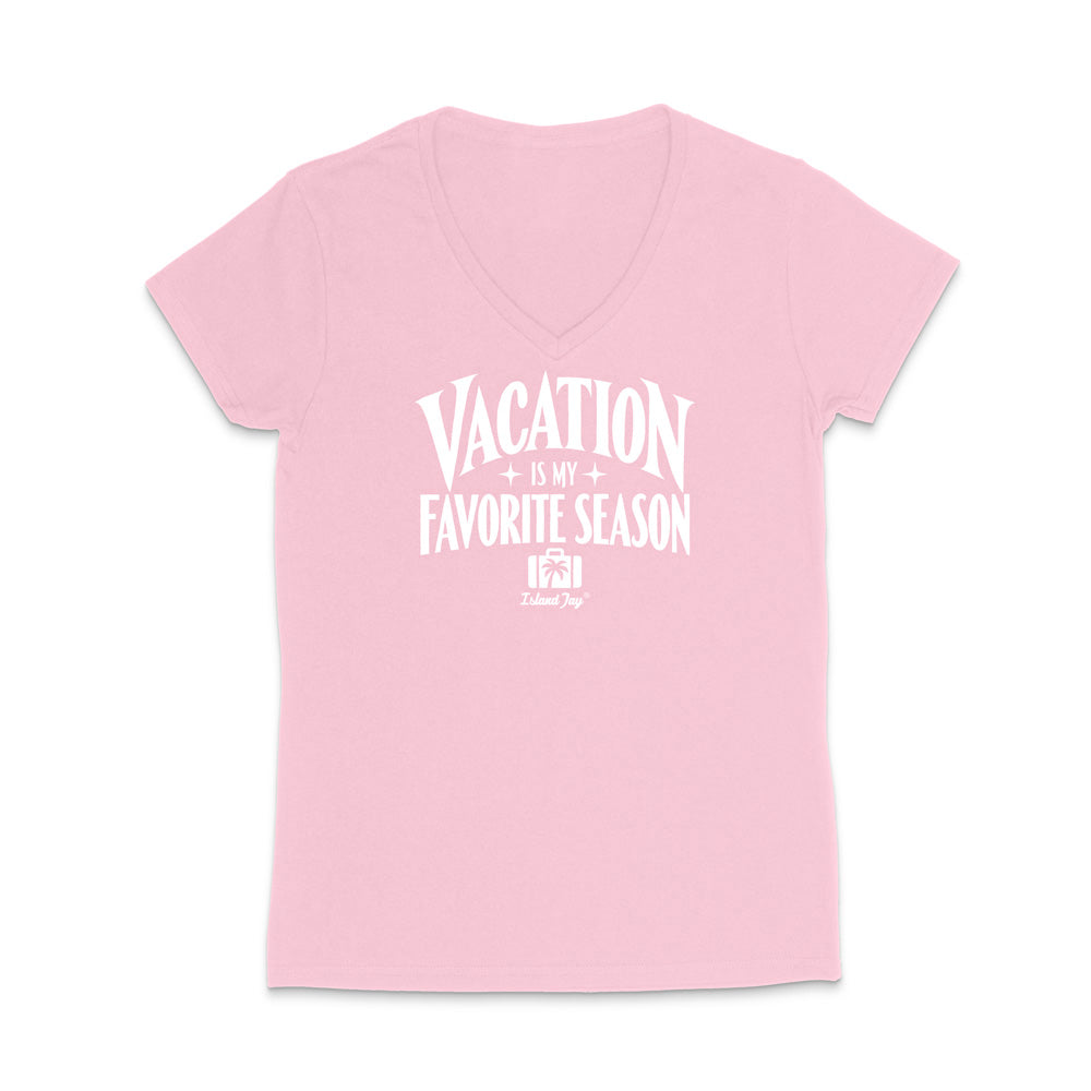 A light pink women's V-neck t-shirt with a white graphic print on the front that reads 'VACATION IS MY FAVORITE SEASON' with a small 'Tulum Trip' logo underneath, displayed on a clean white background.