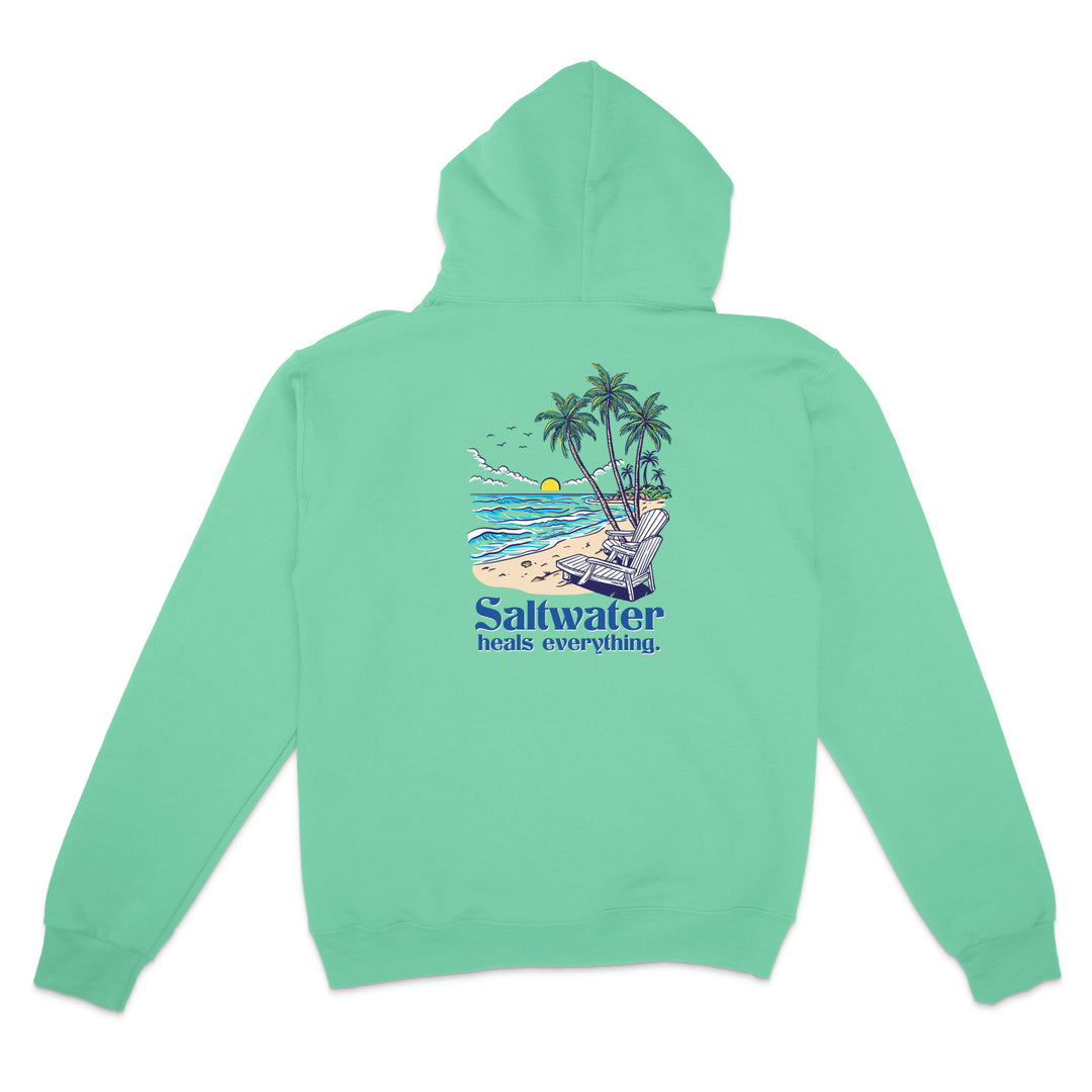 Green hoodie with a beach graphic and 'Saltwater heals everything' text on the back, on a white background.