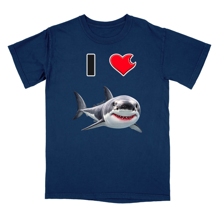 A navy blue short-sleeve t-shirt with a graphic print on the front. The print features a black and white 'I' on the left, a red heart on the right, and a realistic cartoon shark swimming below them.