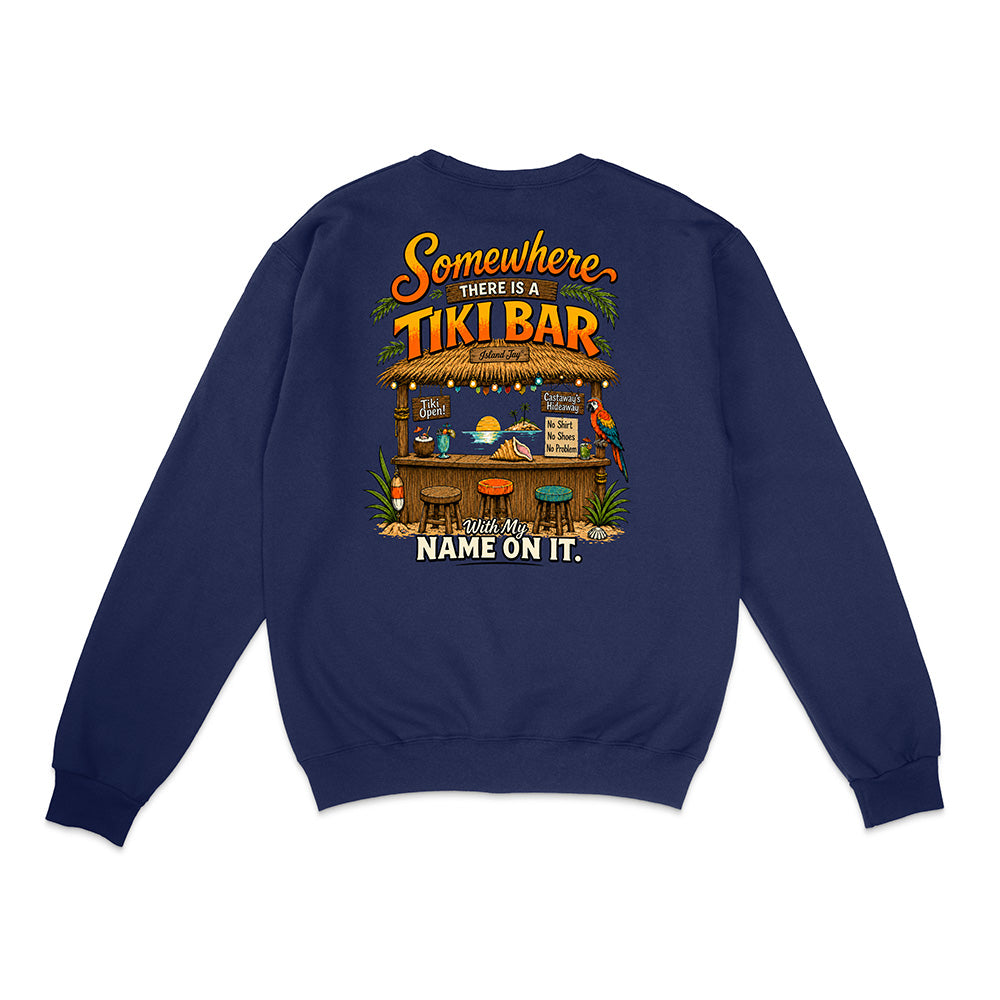 A navy blue crewneck sweatshirt shown from the back, featuring a colorful graphic of a tropical tiki bar with the text 'Somewhere THERE IS A TIKI BAR and my NAME ON IT.'.