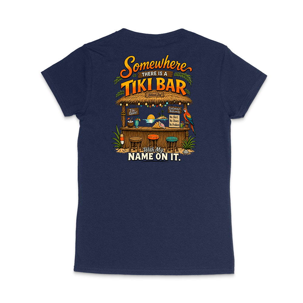 A navy blue short-sleeve t-shirt shown from the back, featuring a colorful graphic print of a tropical 'Tiki Bar' with the text 'Somewhere there is a TIKI BAR' and 'Wish Your NAME ON IT.'.