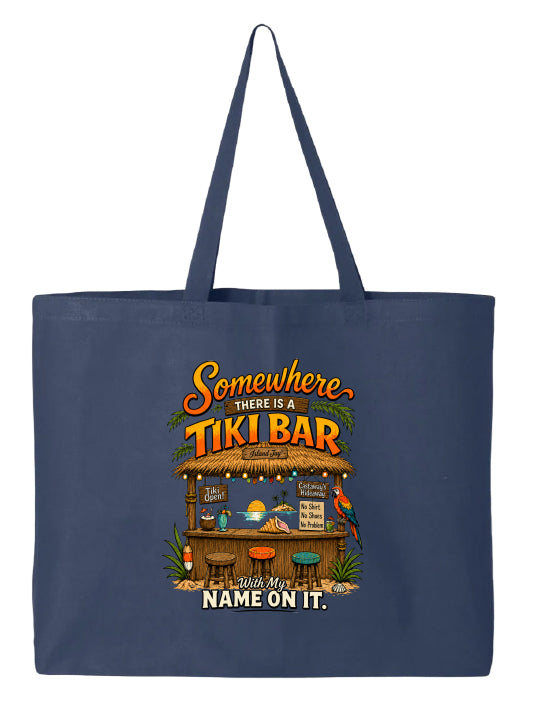 A navy blue canvas tote bag featuring a colorful graphic of a tropical tiki bar with the text 'Somewhere there is a TIKI BAR' and 'your name will be on it.' printed below, shown against a plain white background.