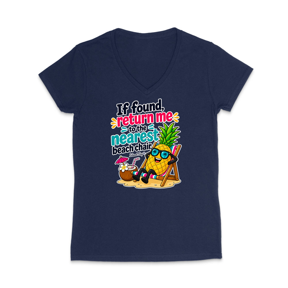 A navy blue women's V-neck t-shirt with a colorful graphic print on the front. The graphic features a pineapple character wearing sunglasses and sitting in a beach chair next to a coconut drink, with the text 'If found, return me to the nearest beach chair' in a playful multicolor font.