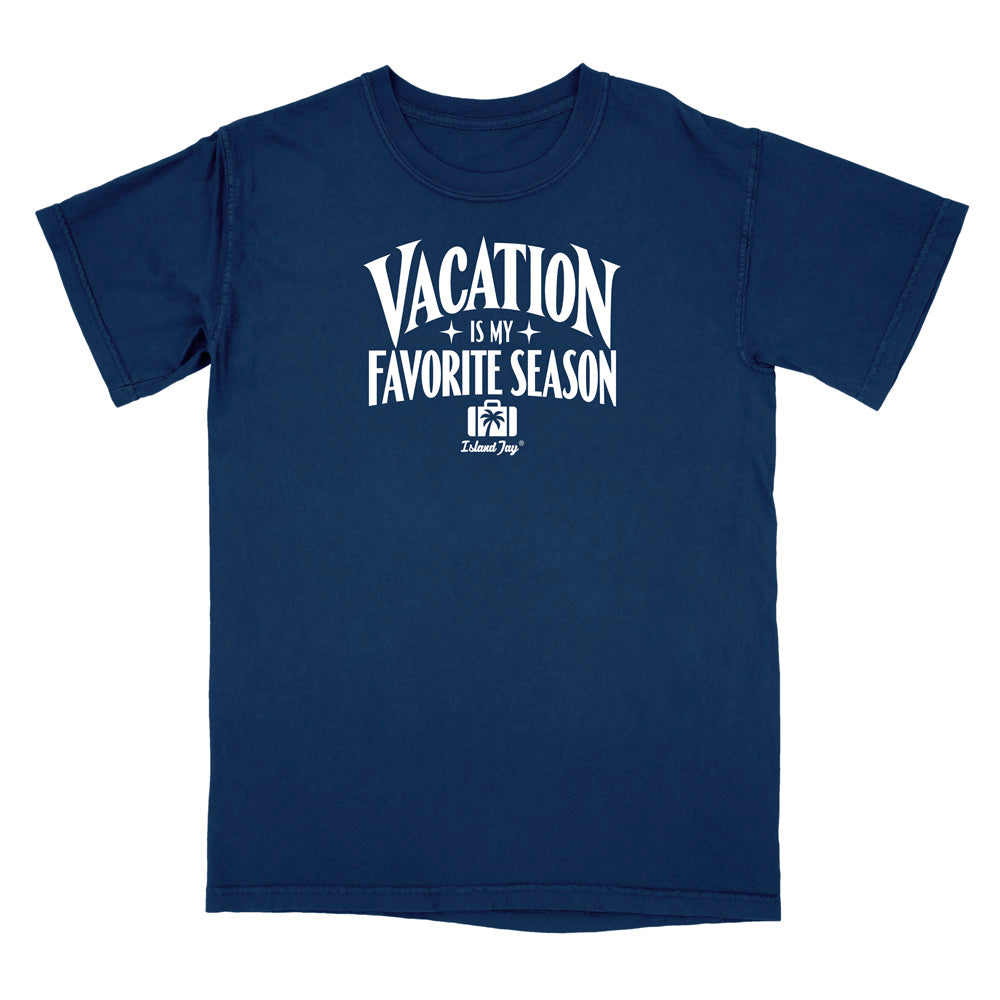 A navy blue short-sleeve t-shirt with a white graphic print on the front that reads 'VACATION IS MY FAVORITE SEASON' with a small 'Delicious Dog' logo underneath, displayed on a solid white background.
