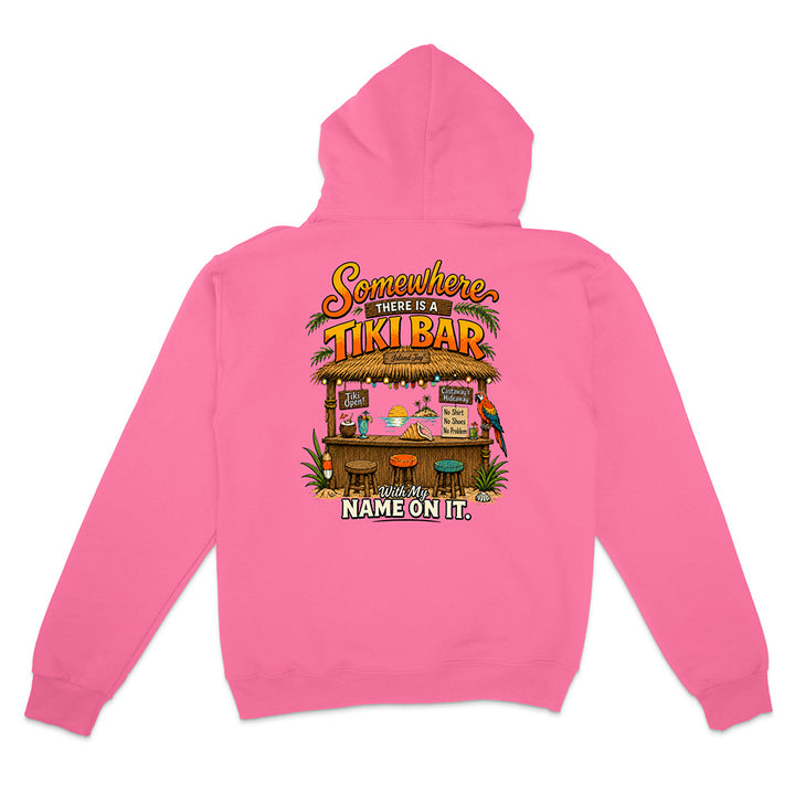 A pink zip-up hoodie shown from the back, featuring a colorful graphic of a tropical 'Tiki Bar' with the text 'Somewhere There Is A TIKI BAR' and 'YOUR NAME ON IT'.
