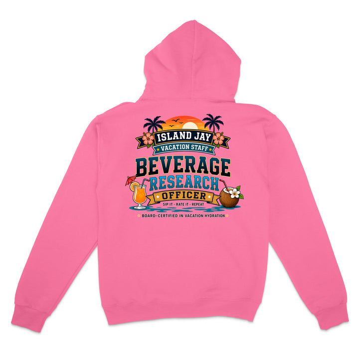 A pink hooded sweatshirt shown from the back, featuring a colorful graphic print that reads 'ISLAND JAY VACATION STAFF BEVERAGE RESEARCH OFFICER' with tropical illustrations including palm trees, a cocktail, and a coconut.