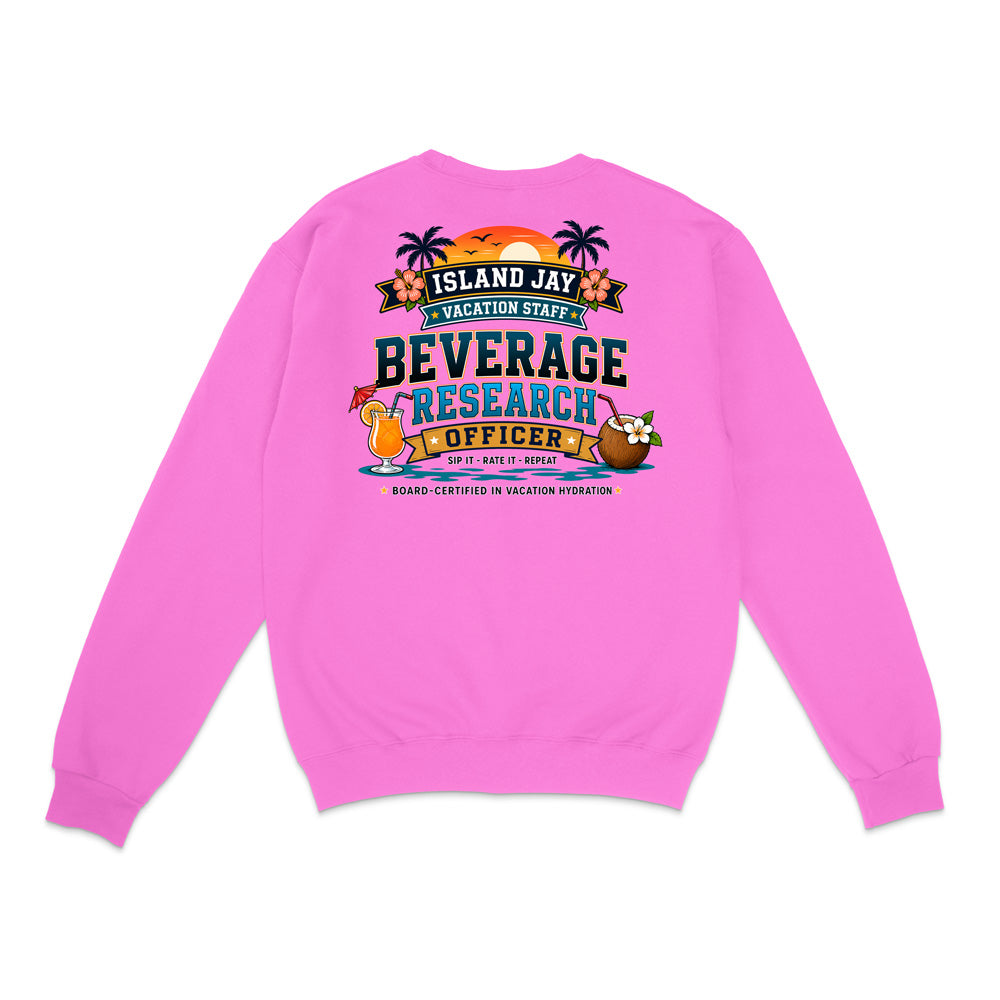 A bright pink crewneck sweatshirt shown from the back, featuring a colorful graphic print with tropical elements and the text 'ISLAND JAY BEVERAGE RESEARCH OFFICER'.
