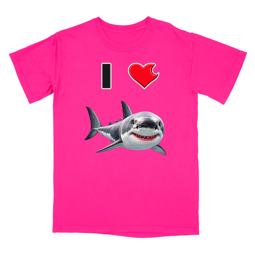 A bright pink short-sleeve t-shirt with a graphic print on the front showing a black and white 'I' followed by a red heart with a bite taken out of it, and a cartoon shark swimming below.