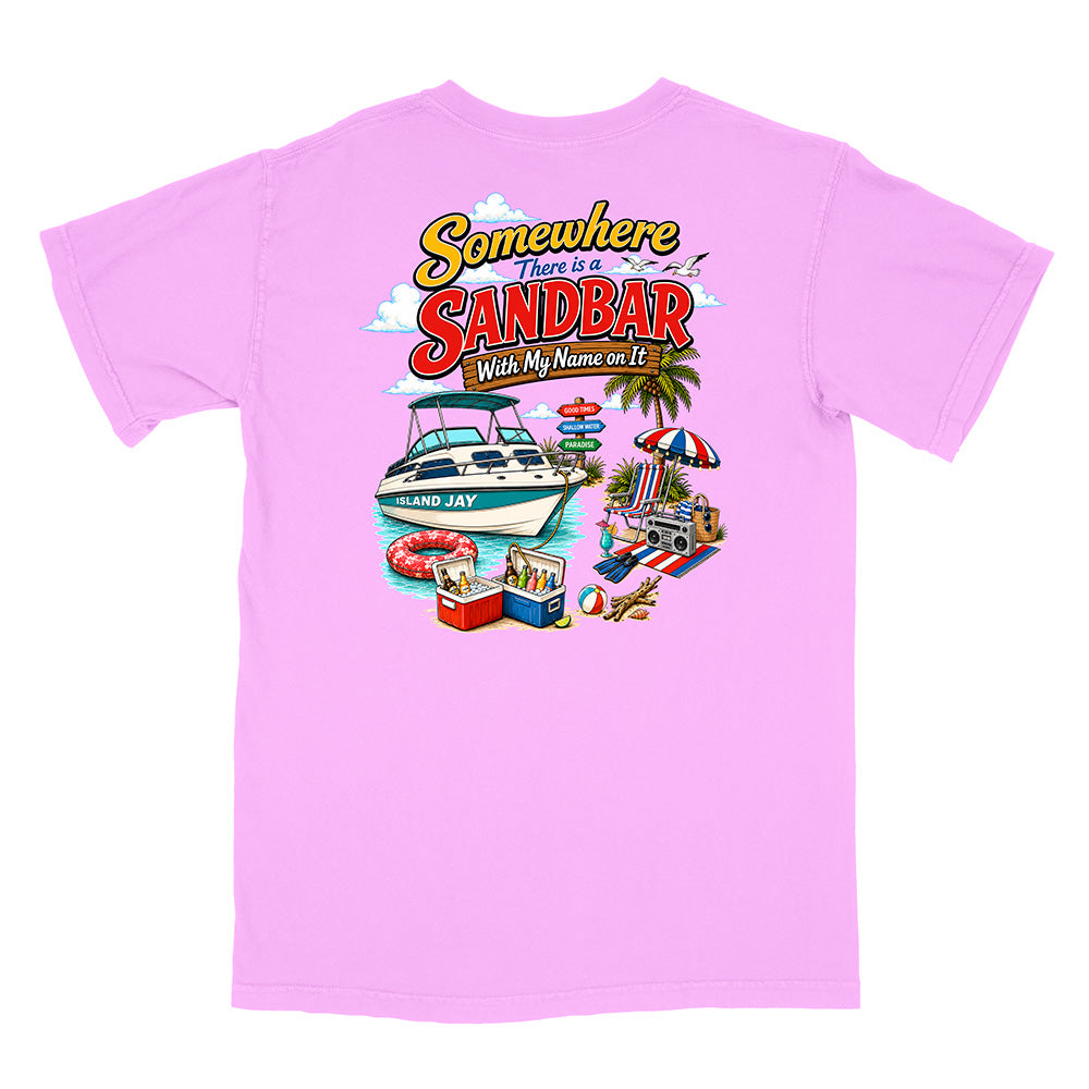 A light pink short-sleeve t-shirt with a colorful graphic print on the back. The graphic features the text 'Somewhere There is a SANDBAR With My Name on It' above an illustration of a white motorboat, a beach umbrella, a cooler, and a beach chair.