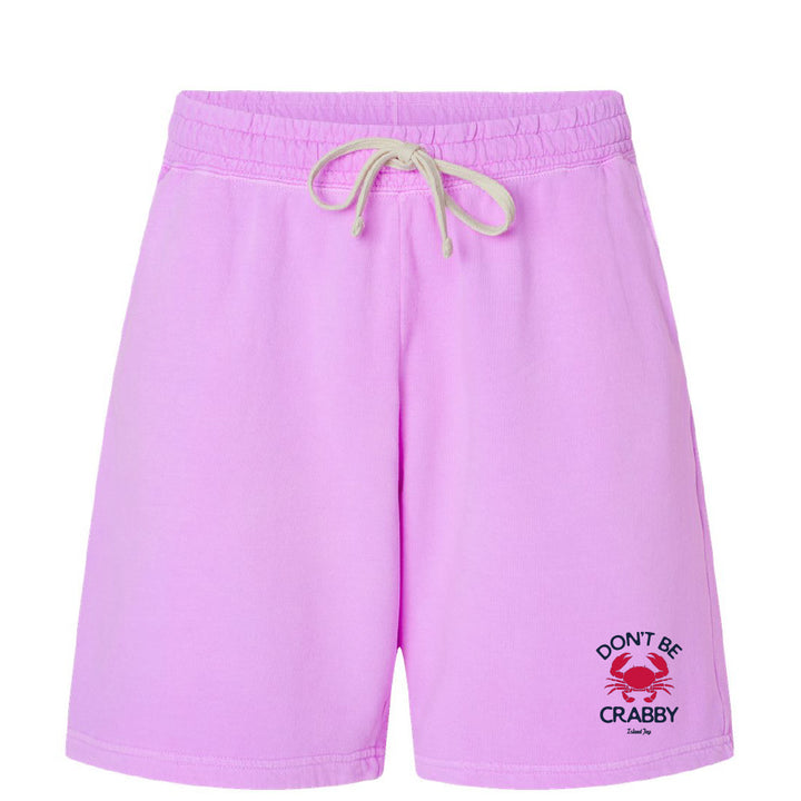 Pink shorts with a crab graphic and text on a white background