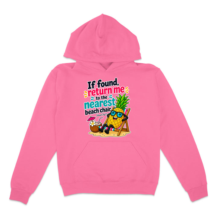 A bright pink pullover hoodie with a colorful graphic on the chest. The graphic features a cartoon pineapple wearing sunglasses and relaxing in a beach chair next to a coconut cocktail, with the text 'If found, return me to the nearest beach chair'.