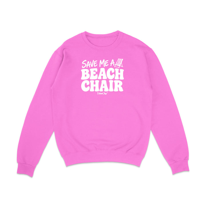 A bright pink crewneck sweatshirt with white graphic text reading 'SAVE ME A BEACH CHAIR' 