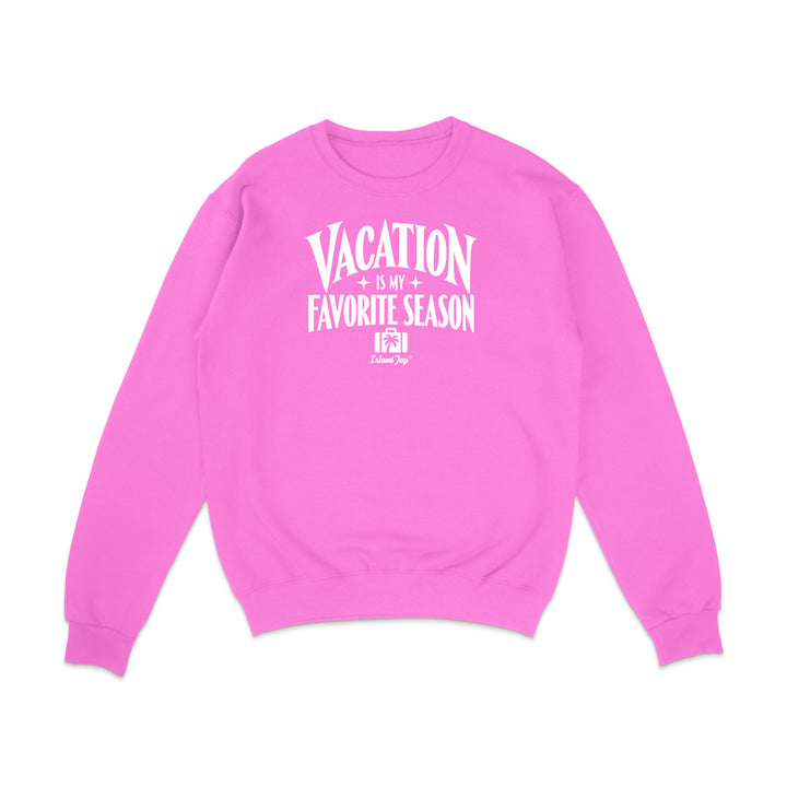 A bright pink crewneck sweatshirt with a white graphic text print reading 'VACATION IS MY FAVORITE SEASON' and a small 'The Daily Dose' logo underneath, displayed on a clean white background.