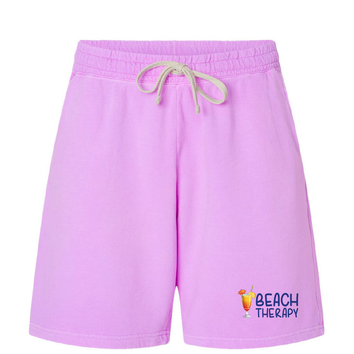 Purple shorts with 'Beach Therapy' text and logo on a white background