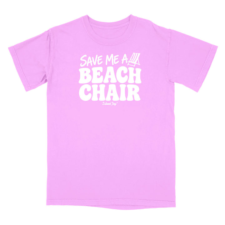 A neon violet short-sleeve t-shirt with a bold white graphic on the chest reading 'SAVE ME A BEACH CHAIR' 