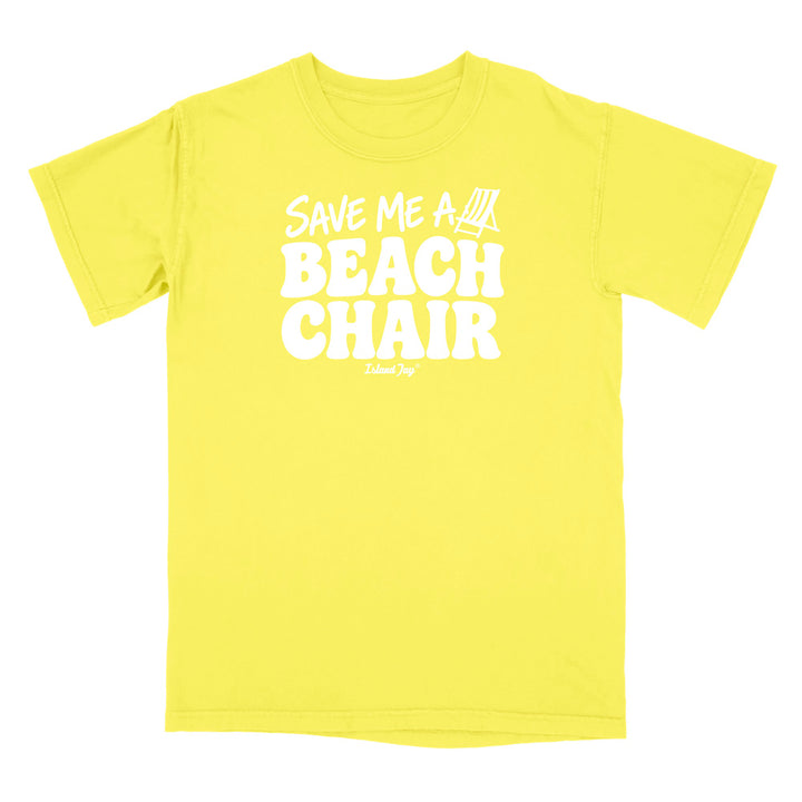 A bright yellow short-sleeve t-shirt with a bold white graphic on the chest reading 'SAVE ME A BEACH CHAIR' 