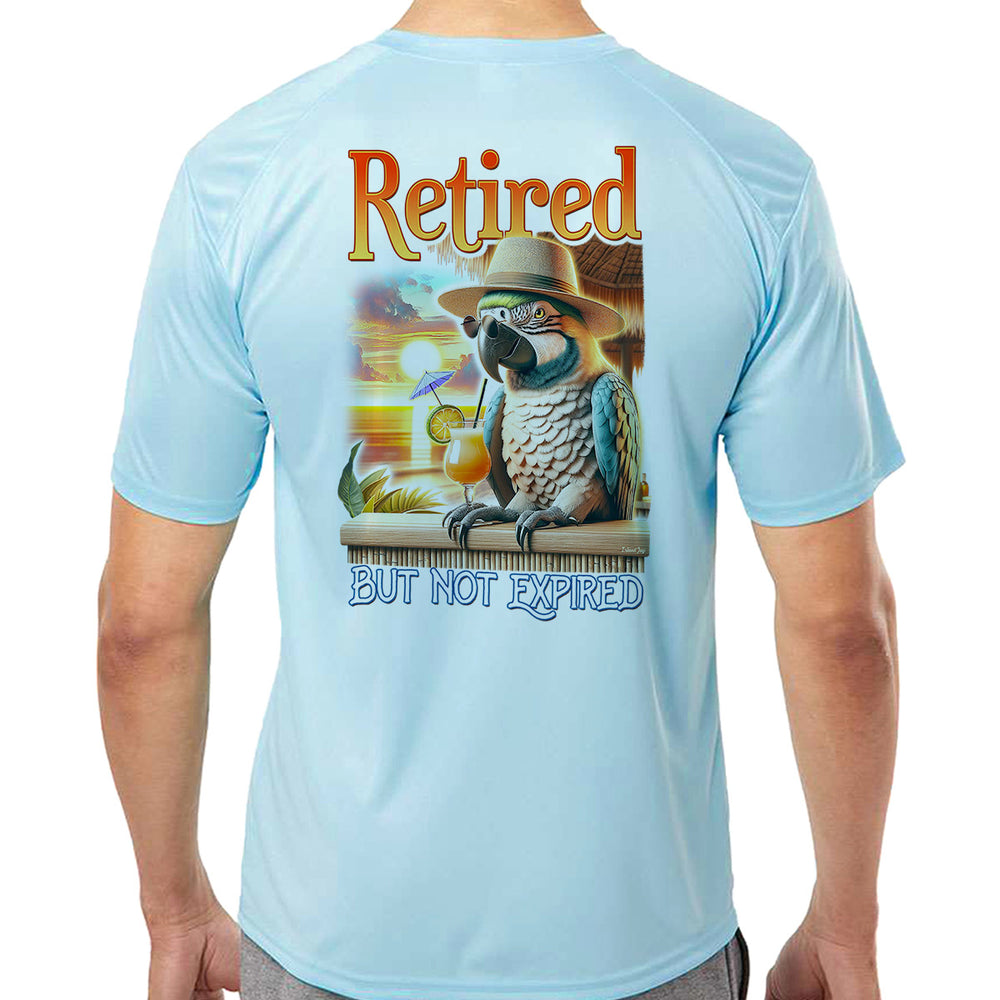 Retired But Not Expired Parrot UV Performance Shirt Ice Blue. Shows a colorful and mature parrot enjoying a drink at a tropical beach bar
