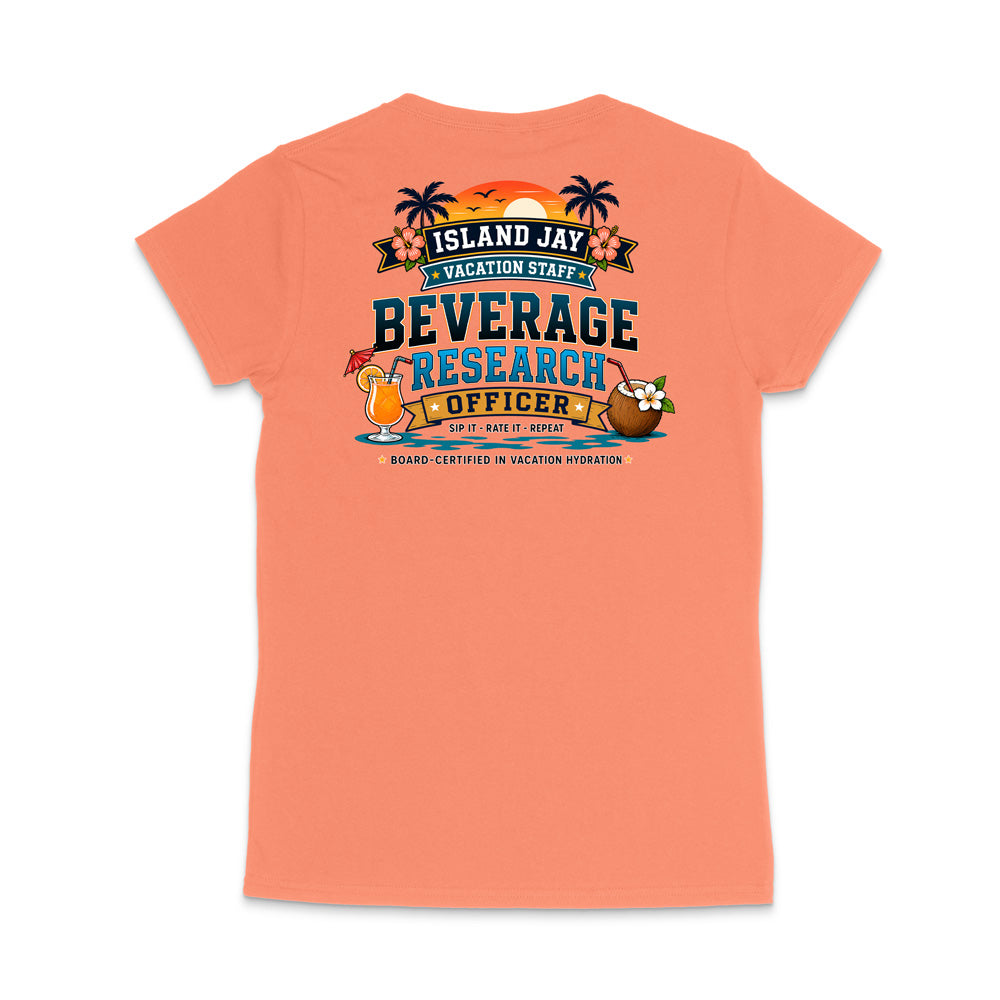 A coral pink short-sleeve t-shirt shown from the back, featuring a colorful graphic print with tropical elements and the text 'ISLAND JAY BEVERAGE RESEARCH OFFICER'.
