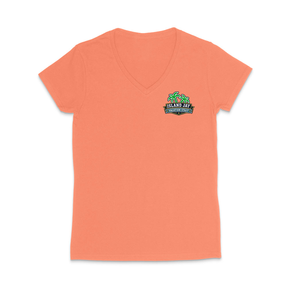 A coral women's short-sleeve V-neck t-shirt with a small colorful graphic on the left chest featuring palm trees and the text 'Island Jay Vacation Staff'.