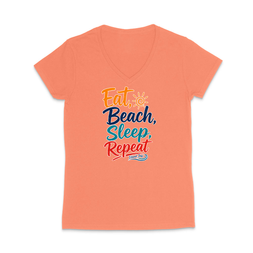 A coral pink V-neck t-shirt with a colorful graphic text design reading 'Eat, Beach, Sleep, Repeat' in orange, navy, and red lettering, displayed on a clean white background.