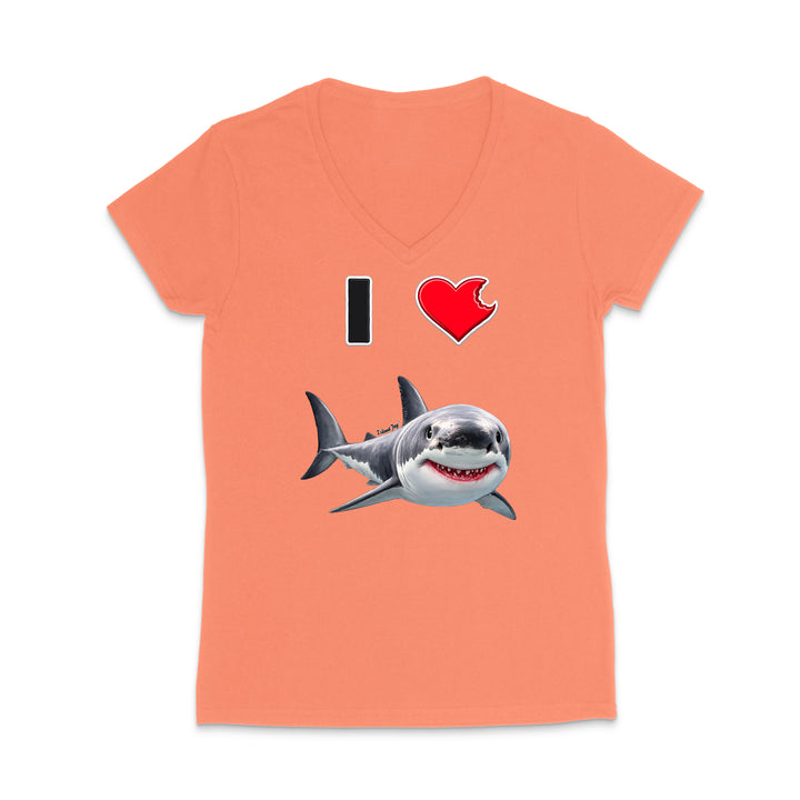 A coral pink women's V-neck t-shirt featuring a graphic print of a shark and the text 'I' followed by a red heart and the shark, displayed on a clean white background.